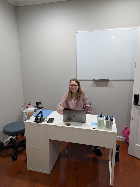 Elaine at her office desk